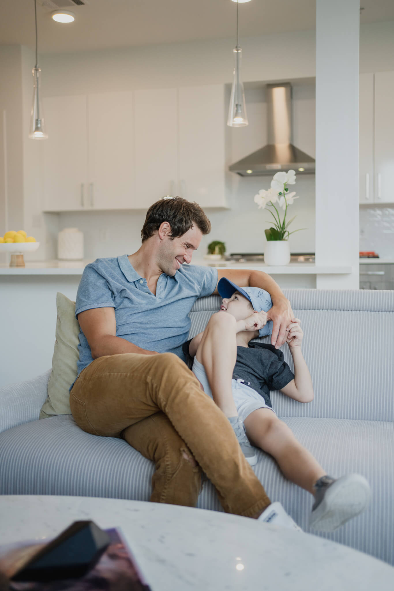 father and child at home in living room on couch